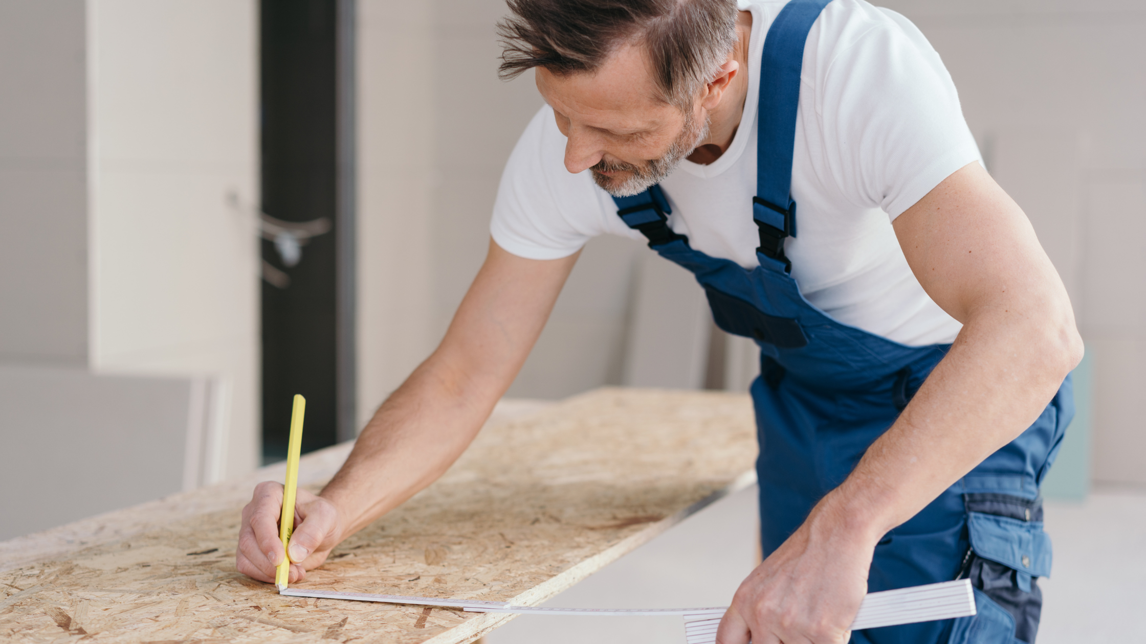 Construction worker installing subflooring